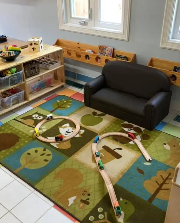 Learning Together Childcare reading area with wooden train tracks and accessible toys
