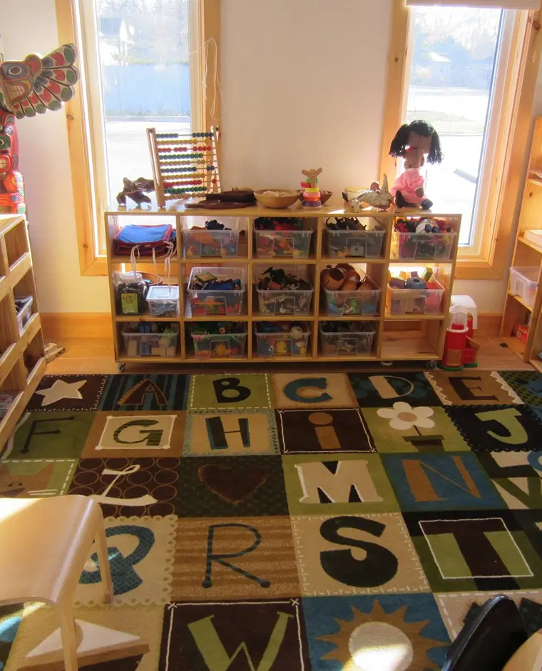 Learning Together Childcare preschool classroom with an alphabet rug and toy shelves