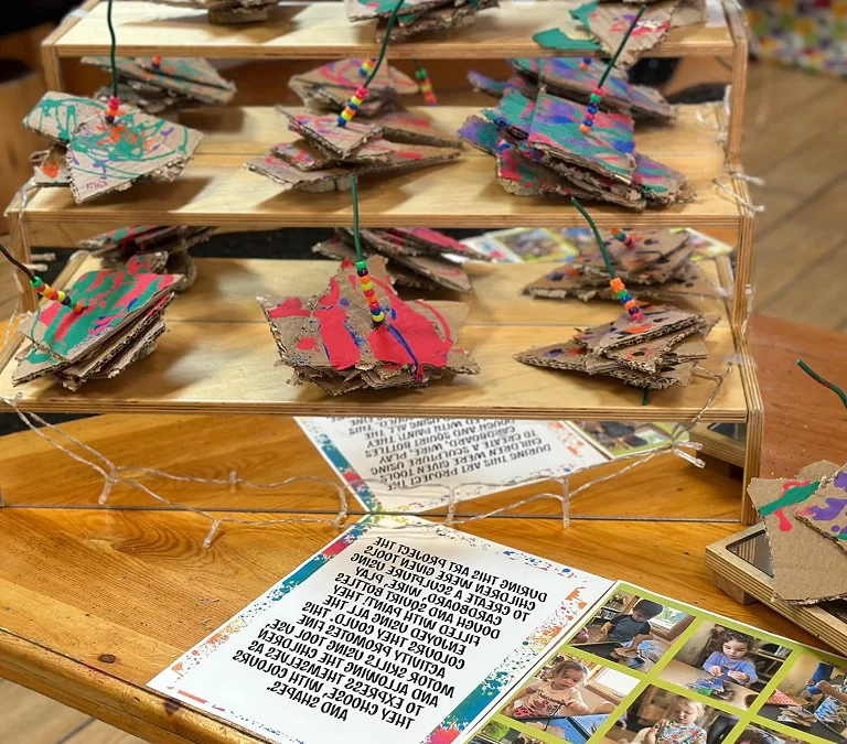 Children’s painted cardboard sculptures with colourful beads displayed at Learning Together Childcare